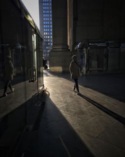 Man walking in corridor of building