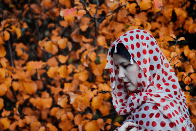 Close-up of child on tree during autumn