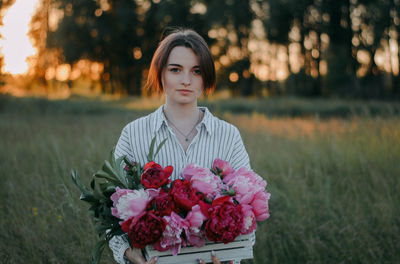 Portrait of a beautiful young woman on field