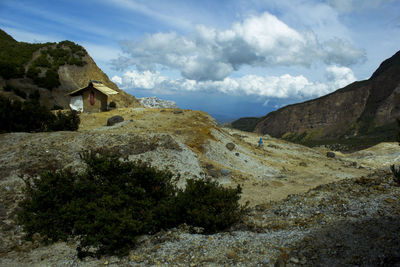 Scenic view of mountains and buildings against sky