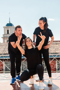 Fitness equipment of three young women on a terrace looking at the camera