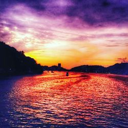 Scenic view of river at sunset