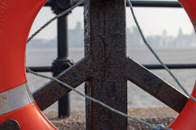 Close-up of life belt on rusty railing