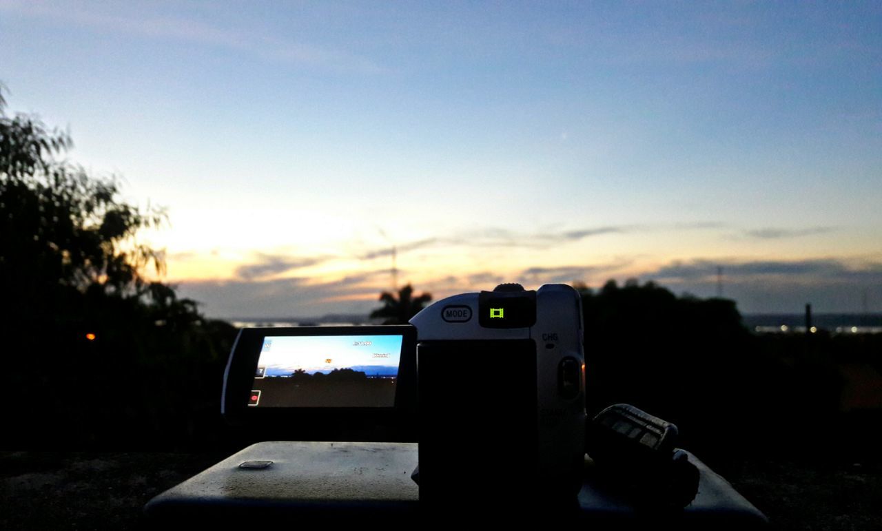 technology, photography themes, sky, device screen, camera - photographic equipment, digital single-lens reflex camera, no people, sunset, close-up, cloud - sky, nature, digital viewfinder, digital camera, outdoors, illuminated, day