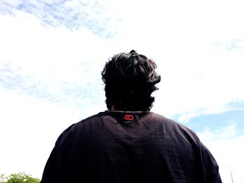 Rear view of man against sky