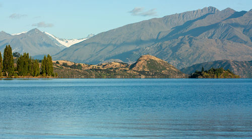 Scenic view of lake and mountains against sky