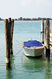 Boat moored in sea against sky