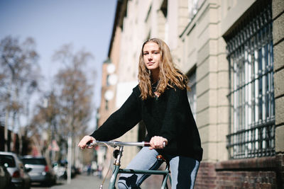 Happy woman with bicycle in city