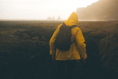 Rear view of man standing on field