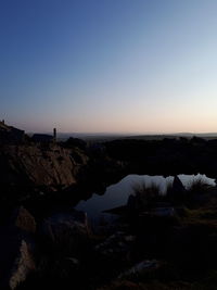 Scenic view of sea against clear sky at sunset