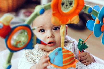 Sweet baby playing with colorful toys