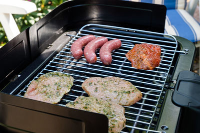 High angle view of meat on barbecue grill