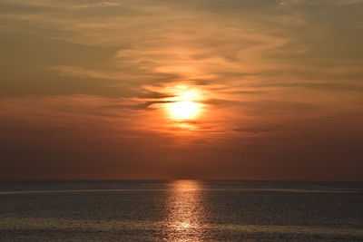 Scenic view of sea against orange sky