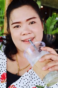 Close-up portrait of woman having drink