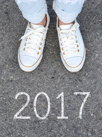 Low section of man standing on road