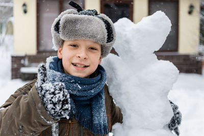 Portrait of boy with snowman