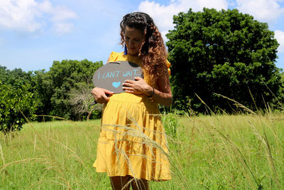 Man standing on field against trees
