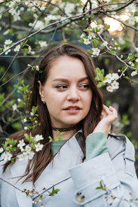 Portrait of a beautiful girl in cherry blossoms in spring