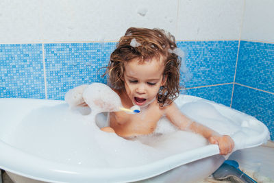 Girl taking bath in bathtub