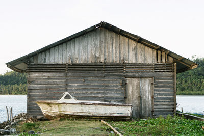 Boathouse against clear sky