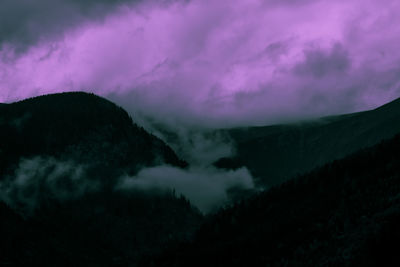 Scenic view of mountains against sky at dusk