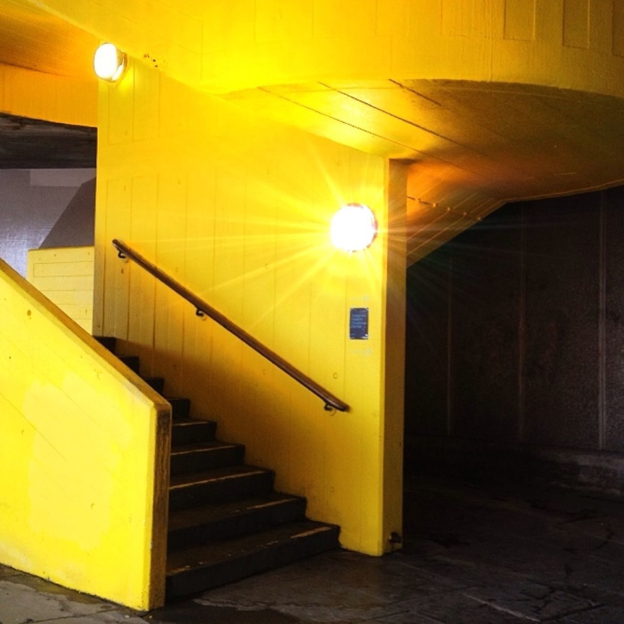 indoors, illuminated, steps and staircases, steps, staircase, yellow, built structure, architecture, lighting equipment, railing, ceiling, wall - building feature, escalator, absence, empty, modern, convenience, subway station, public transportation, no people