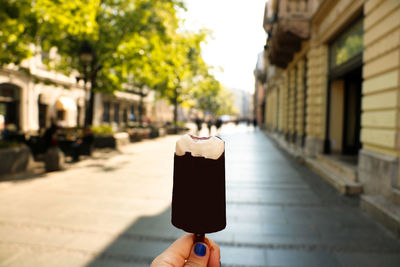 Close-up of hand holding ice cream