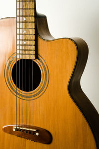 Close-up of guitar against gray background