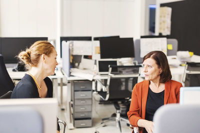Mature businesswomen discussing in office
