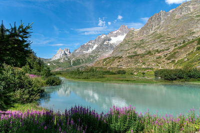 Scenic view of lake and mountains against sky