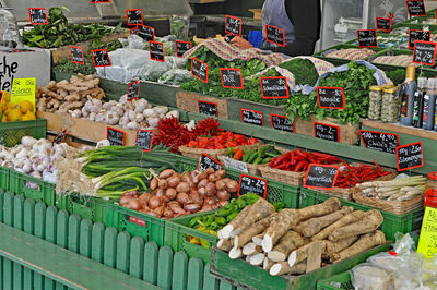 Vegetables in crates at market for sale