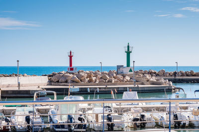 View of lighthouse by sea against sky