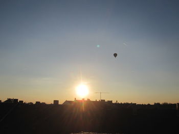 Silhouette of hot air balloon against sky during sunset