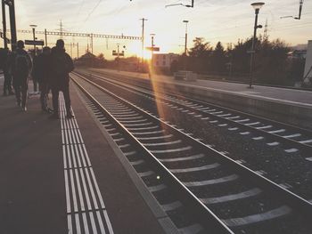 Railroad station against sky at sunset