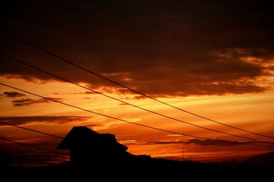 Low angle view of power lines against sky