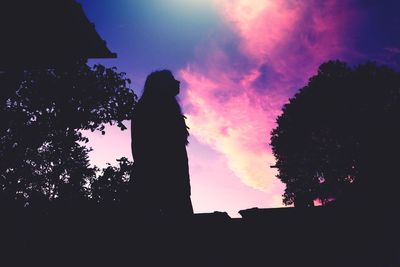 Low angle view of silhouette trees against sky at sunset