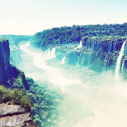 Panoramic view of waterfall against clear sky