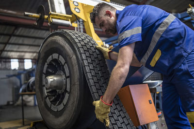 Tire repairer applying tire tread