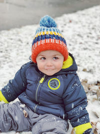 Portrait of cute boy standing on snow