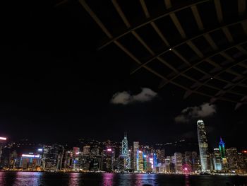 Illuminated buildings in city against sky at night
