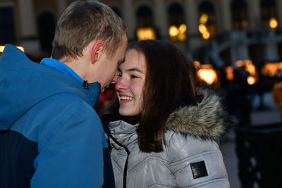Young couple teasing each other at the christmas market.