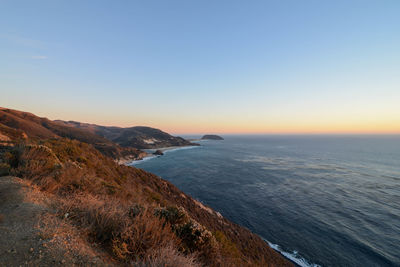 Scenic view of sea against clear sky during sunset