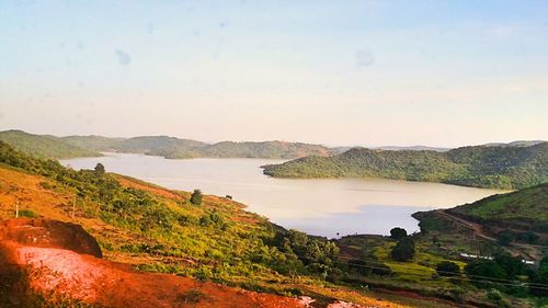 Scenic view of lake and mountains against sky