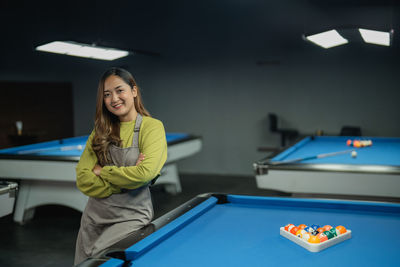 Midsection of woman playing pool