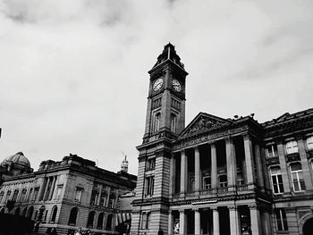 Low angle view of building against cloudy sky