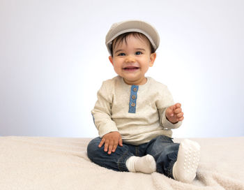 Portrait of a smiling boy sitting on floor