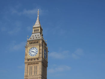 Low angle view of big ben against blue sky