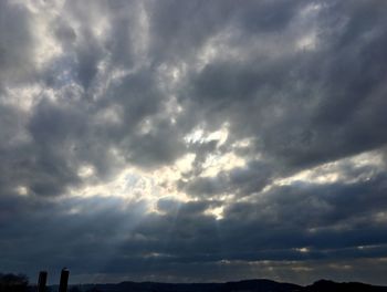Silhouette of landscape against cloudy sky