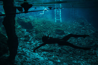 Woman swimming under sea