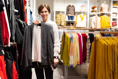 Portrait of smiling woman shopping clothes